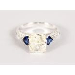A SUPERB CUSHION CUT DIAMOND RING of 2.5CTS with sapphire and diamond shoulders.