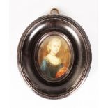 A SMALL 18TH CENTURY OVAL PORTRAIT MINIATURE OF A YOUNG GIRL, wearing a lace frilled dress. 6cms x