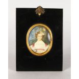 A SMALL 19TH CENTURY OVAL PORTRAIT MINIATURE OF A YOUNG GIRL holding a posy. 6cms x 4.5cms, with