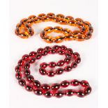 TWO STRINGS OF AMBER BEADS.
