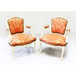 A PAIR OF FRENCH STYLE FAUTEUIL ARMCHAIRS, curved and painted, foliate upholstery (2).