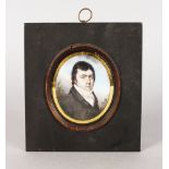 AN 18TH CENTURY OVAL PORTRAIT MINIATURE OF A GENTLEMAN wearing a dark coat and white cravat. 7cms