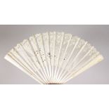 A LARGE WHITE LACE FAN. 17ins, open in a wooden box.