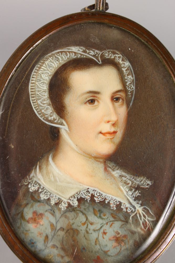 A 19TH CENTURY OVAL PORTRAIT MINIATURE OF A YOUNG LADY in Tudor type dress with lace bonnet. 8cms - Image 2 of 2