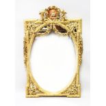 A DECORATIVE GILT FRAMED PIER MIRROR, 20TH CENTURY, with cherub cresting and floral swags. 3ft 11ins