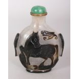 A CHINESE BLACK OVERLAY GLASS SNUFF BOTTLE & STOPPER, each side decorated with a horse reserved on a