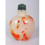 AN UNUSUAL CHINESE GLASS SNUFF BOTTLE & STOPPER, the opaque body with scattered red and orange