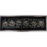 A CHINESE SILK EMBROIDERED FABRIC WALL HANGING, with a silk border, the hanging decorated with