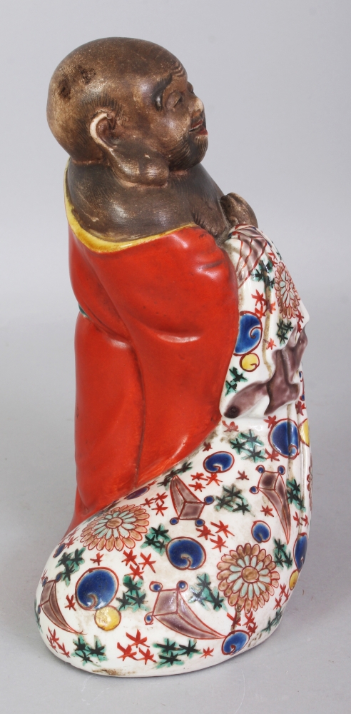 A JAPANESE MEIJI PERIOD KUTANI PORCELAIN FIGURE OF HOTEI, standing with a cheerful expression and - Image 2 of 7