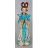 A TANG STYLE TURQUOISE GLAZED CERAMIC FIGURE OF A STANDING LADY, 7.5in high.