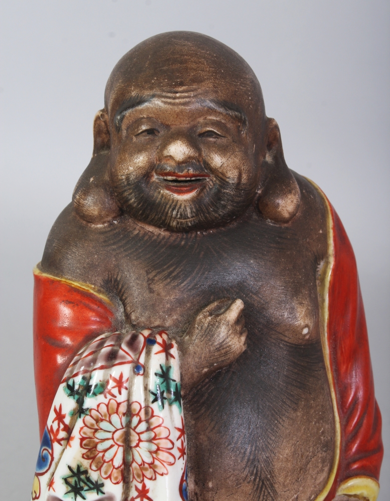 A JAPANESE MEIJI PERIOD KUTANI PORCELAIN FIGURE OF HOTEI, standing with a cheerful expression and - Image 5 of 7