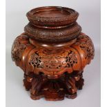 A LARGE JAPANESE MEIJI PERIOD CARVED & PIERCED WOOD VASE OR TUSK STAND, with a revolving platform