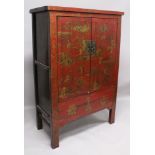 A LARGE EARLY 20TH CENTURY CHINESE RED GROUND LACQUERED WOOD CABINET, with two hinged front doors