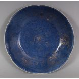 A CHINESE KANGXI PERIOD GILT DECORATED POWDER BLUE PORCELAIN SAUCER, circa 1700, of lobed hexafoil