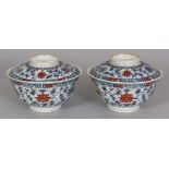 A PAIR OF CHINESE DOUCAI PORCELAIN BOWLS & COVERS, each decorated with formal scrolling