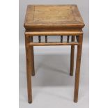 A 19TH CENTURY CHINESE CARVED WOOD SQUARE SECTION STAND, supported on circular legs and with a