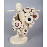 ANOTHER A FINE QUALITY SIGNED JAPANESE SECTIONAL IVORY OKIMONO OF A DRUM SELLER, carrying drums,