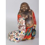 A JAPANESE MEIJI PERIOD KUTANI PORCELAIN FIGURE OF HOTEI, standing with a cheerful expression and