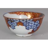 A 20TH CENTURY JAPANESE IMARI STYLE PORCELAIN TEABOWL, the side with a maker's mark, the base