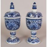 A PAIR OF CHINESE KANGXI STYLE BLUE & WHITE PORCELAIN STEM BOWLS & COVERS, each decorated with