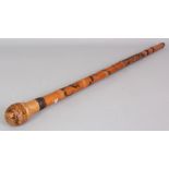 AN EARLY 20TH CENTURY SIGNED JAPANESE BAMBOO WALKING STICK, carved with a dragon in clouds above a