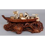 A GOOD QUALITY JAPANESE MEIJI PERIOD IVORY & WOOD OKIMONO, in the form of a boat bearing Ebisu and