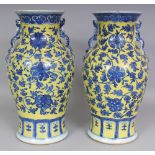 A LARGE PAIR OF 19TH CENTURY YELLOW GROUND BLUE & WHITE PORCELAIN VASES, each painted with formal