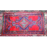 A TURKISH RUG with red and blue pattern. 4ft 2ins x 2ft 3ins.