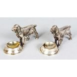 A PAIR OF SILVER RETRIEVERS with feeding bowl. 4ins long.