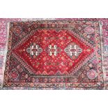 A PERSIAN RUG with three large Tri-Color motifs. 5ft 2ins x 3ft 9ins.