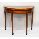 A GEORGE III HALF MOON CARD TABLE with crossbanded rising top, green baize interior, supported on