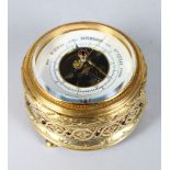 A SUPERB RUSSIAN SILVER GILT CIRCULAR TABLE BAROMETER by BOLIN, the case set with cabochon garnets