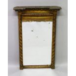 A REGENCY CARVED AND GILDED UPRIGHT PIER MIRROR with bead frieze and barley twist supports. 2ft 5ins