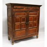 AN 18TH CENTURY OAK STANDING CUPBOARD with three small drawers over double panel doors, enclosing