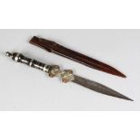 AN ENGRAVED MOORISH DAGGER in a leather sheath. 16ins long.