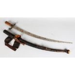 AN EARLY 20TH CENTURY EASTERN SWORD, with wooden hilt, brass guard and curving blade in an