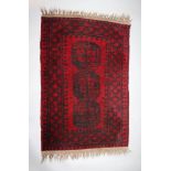 A BELOUCH RED GROUND RUG. 3ft x 1ft 11ins.