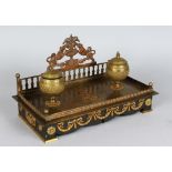 AN EMPIRE BRONZE AND GILT TWO BOTTLE INKSTAND with original glass liners. 12ins long.