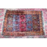 A PERSIAN RUG with blue and maroon ground within an orange M pattern border. 5ft 9ins x 3ft 7ins.