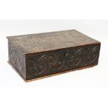 A 17TH CENTURY CARVED OAK BIBLE BOX, carved with fleur-de-lys. 1ft 11ins wide.