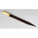 A 19TH CENTURY ISLAMIC BONE HANDLED KNIFE with scripted blade. 21ins long.