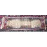 AN UNUSUAL LONG PERSIAN RUG. 7ft 4ins x 2ft 4ins.