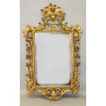 A GOOD GEORGIAN STYLE GILT UPRIGHT MIRROR with acanthus scrolls and baskets of flowers. 4ft 6ins