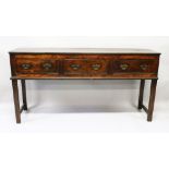 AN 18TH CENTURY OAK LONG DRESSER BASE with plain top, three small frieze drawers with brass handles,