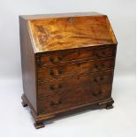 A GEORGE III MAHOGANY BUREAU, with fall front and fitted interior, over three long graduated drawers