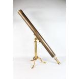 A 19TH CENTURY BRASS STANDING TELESCOPE on a tripod stand.