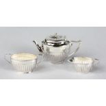 A THREE PIECE MINIATURE SILVER TEA SET.