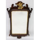A GEORGE III MAHOGANY FRETWORK MIRROR with gilt eagle and bevelled glass. 2ft 11ins high x 1ft