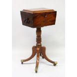 A REGENCY MAHOGANY TEAPOY, the top with fitted interior and glass mixing bowl, on a turned centre