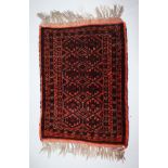 A SMALL PERSIAN RUG. 1ft 10ins x 1ft 4ins.